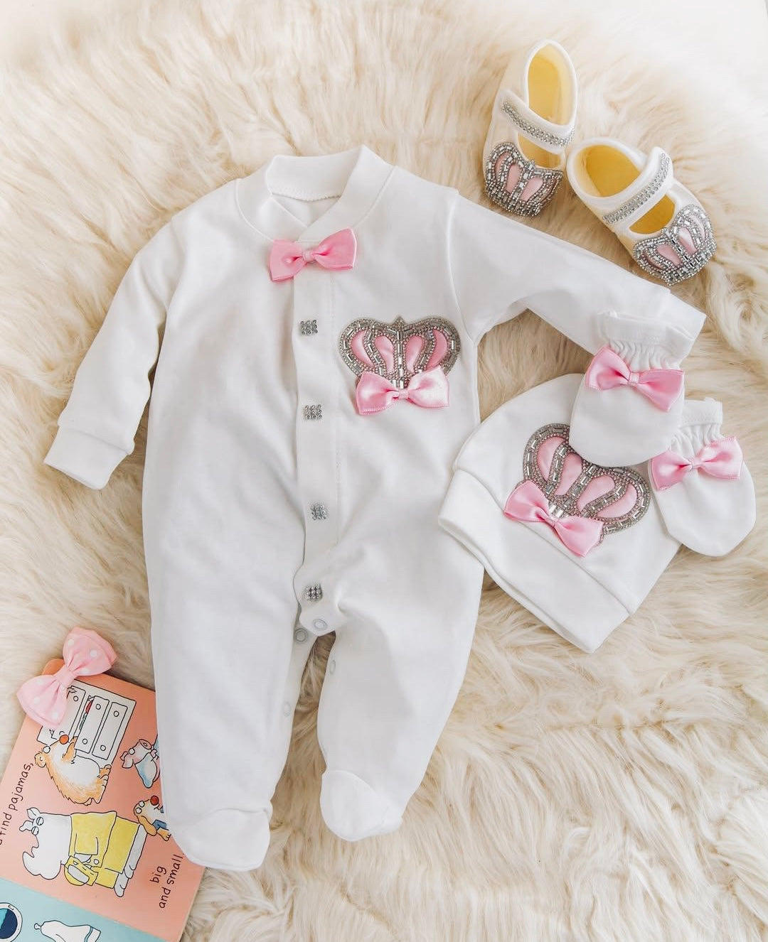 Luxury baby romper with pink bow and crown, matching hat, booties, and organic cotton set