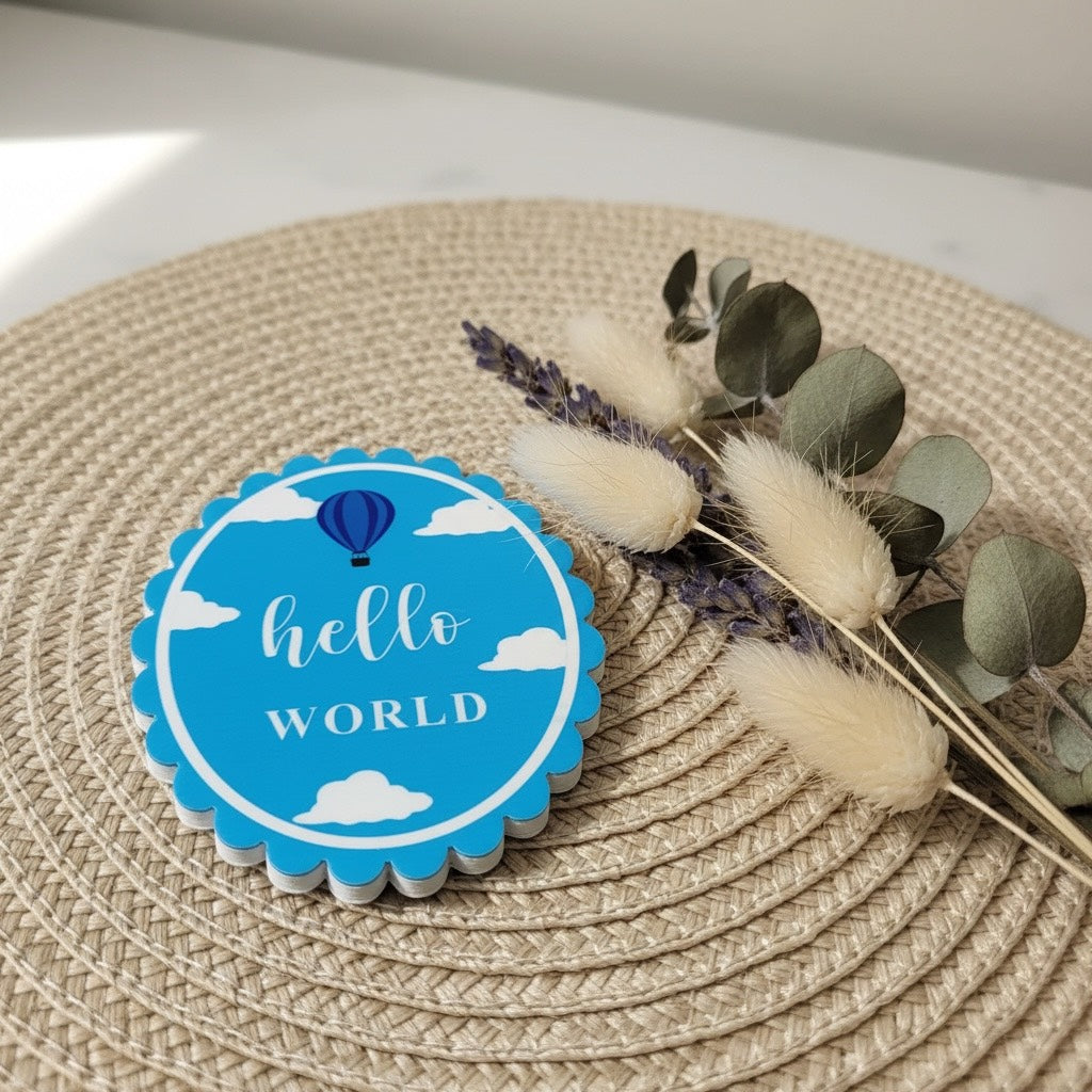 Hello World baby announcement tag with hot air balloon, perfect for newborn gifts and organic cotton babywear