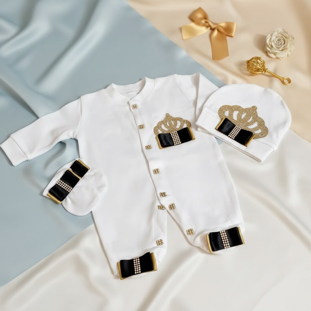 Luxury white baby romper with gold crown and black bows, matching hat and booties, organic cotton babywear