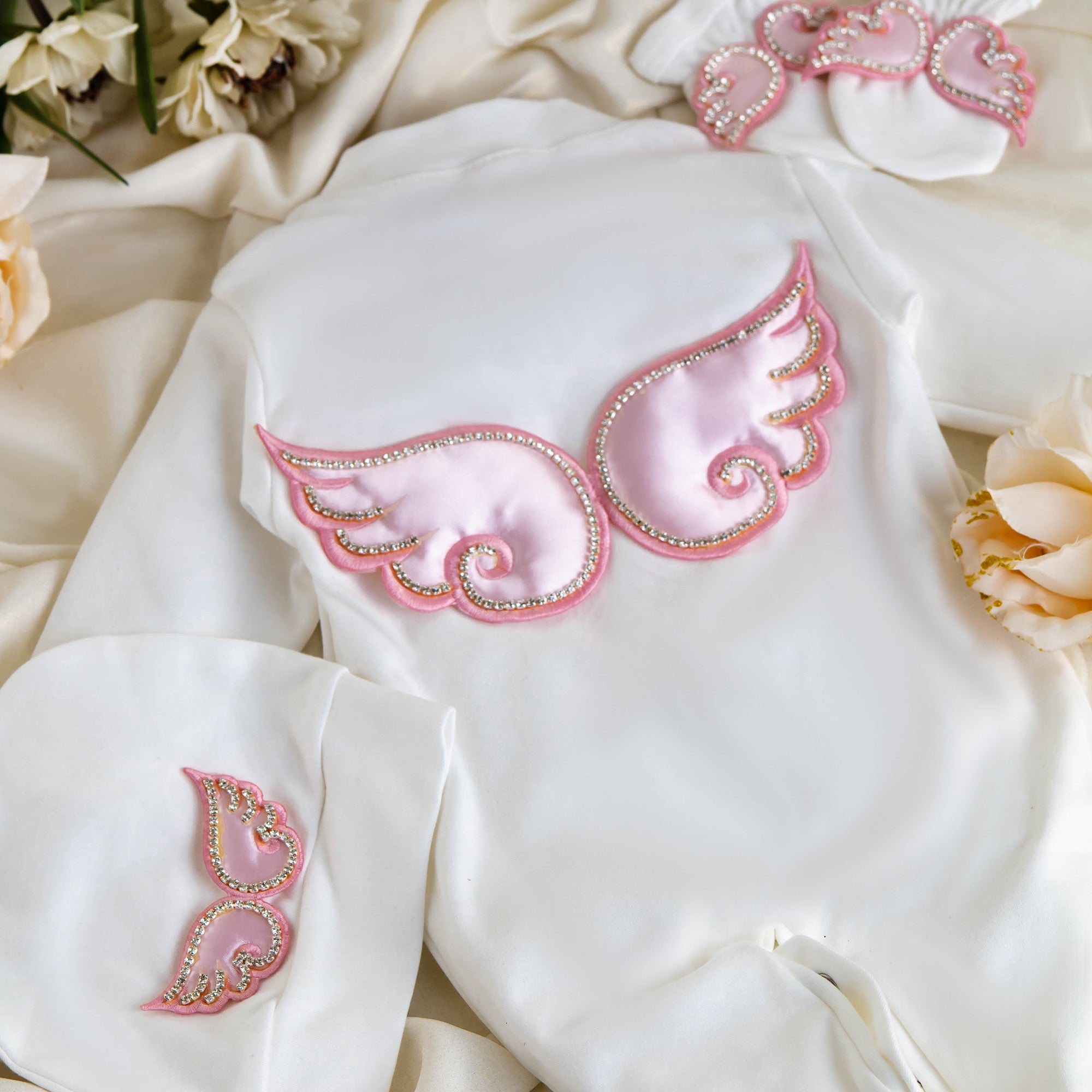 White baby romper with pink satin angel wings and rhinestone trim, luxury newborn outfit