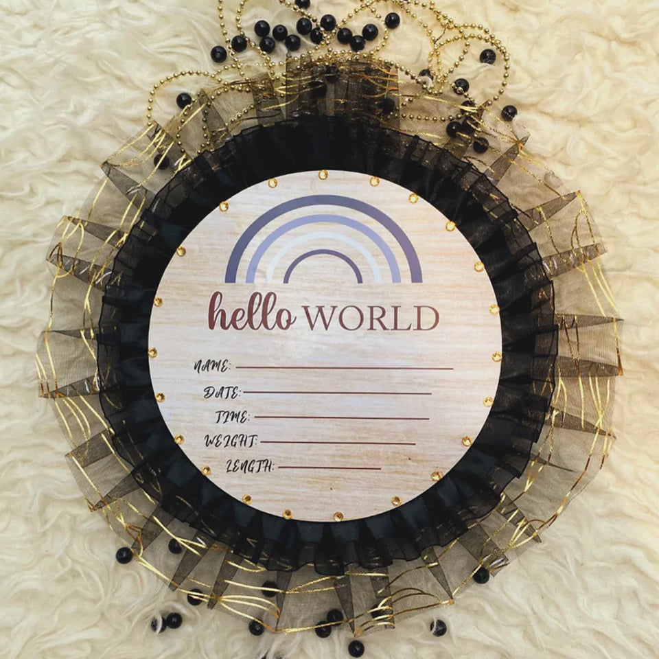 Hello World baby announcement sign with rainbow design, black and gold tulle, and fill-in details for newborn info.