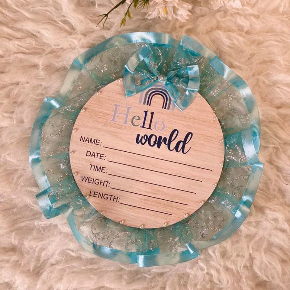 Hello World baby announcement plaque with blue ribbon, perfect for newborn keepsakes