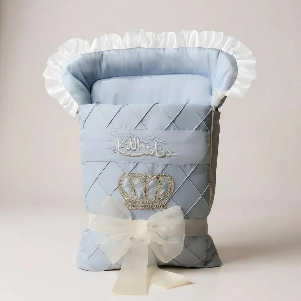 Luxury baby gift set with quilted blue design, crown embroidery, and white ruffle trim for newborns