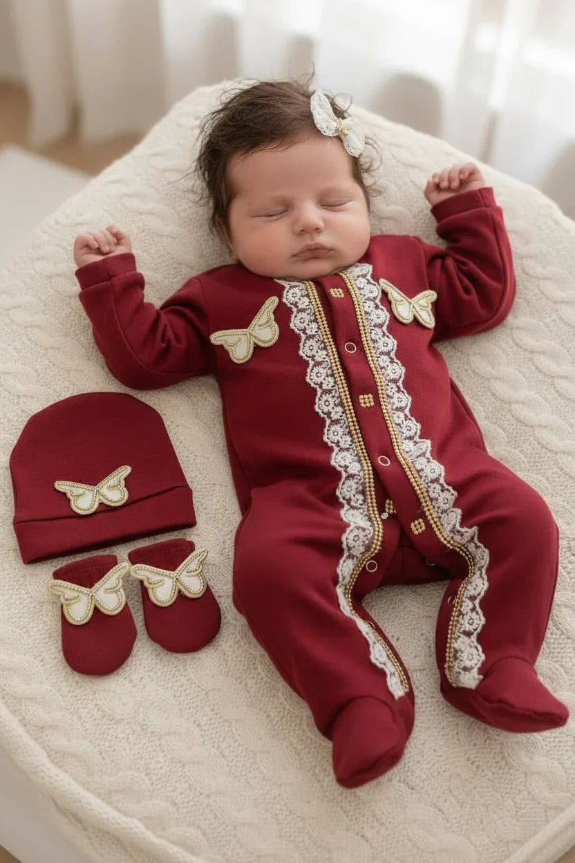 Luxury newborn baby romper set with lace, gold trim, and butterfly appliques in burgundy, matching hat and booties.