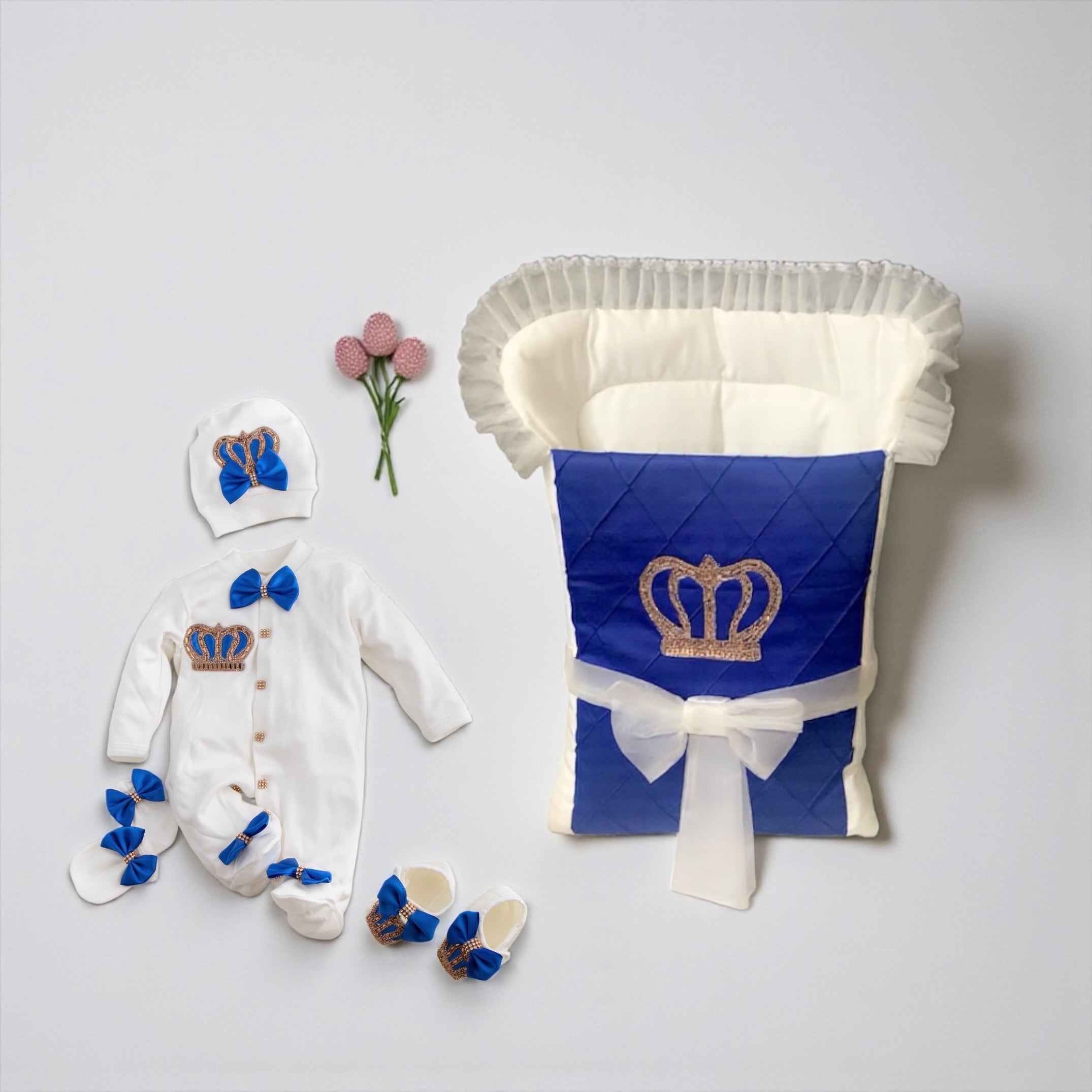 Luxury newborn baby outfit with royal blue crown design, matching hat, booties, and quilted carrier for baby gift sets.